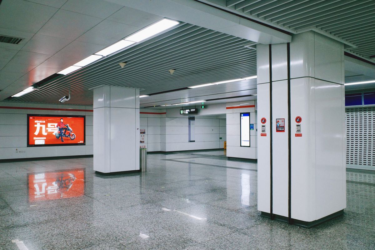 Modern, spacious metro station interior typical of Guangzhou’s clean, English-signed subway system.