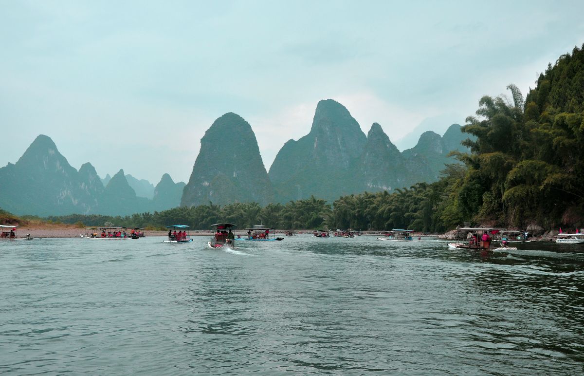 Tour boats on the Li River with karst mountain backdrop near Yangshuo