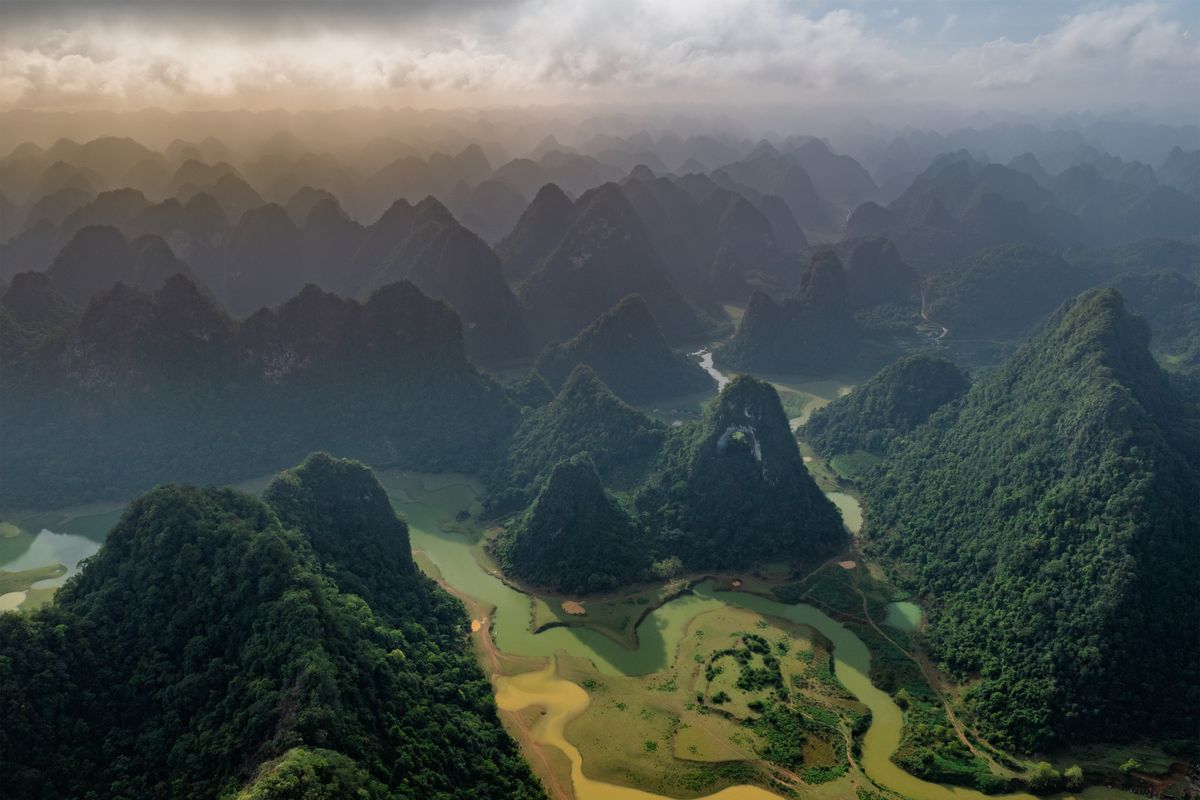 Misty sunrise over karst mountains and the winding Li River