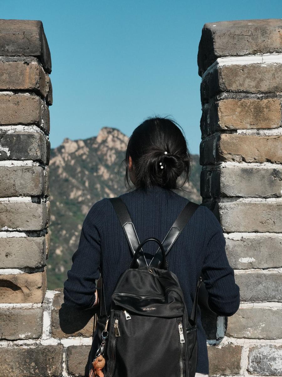 A traveler taking in the view from the Great Wall at Mutianyu