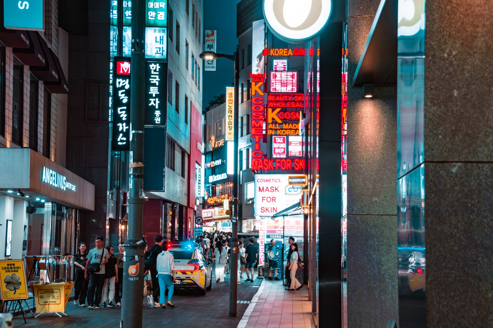 Myeongdong at night with illuminated shop signs and busy foot traffic