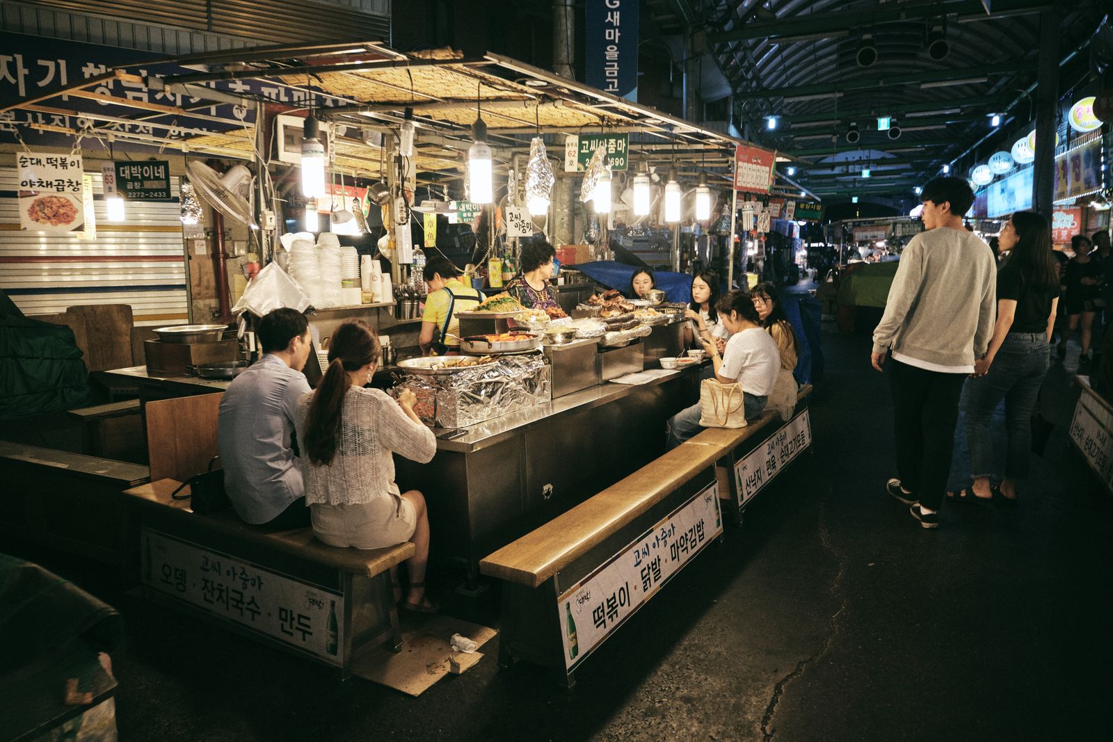 Street food stalls and crowds at a Seoul night market similar to Myeongdong