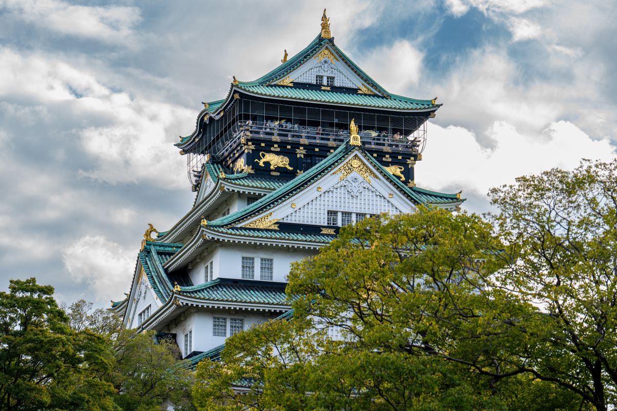 Osaka Castle architecture surrounded by greenery near hotel districts