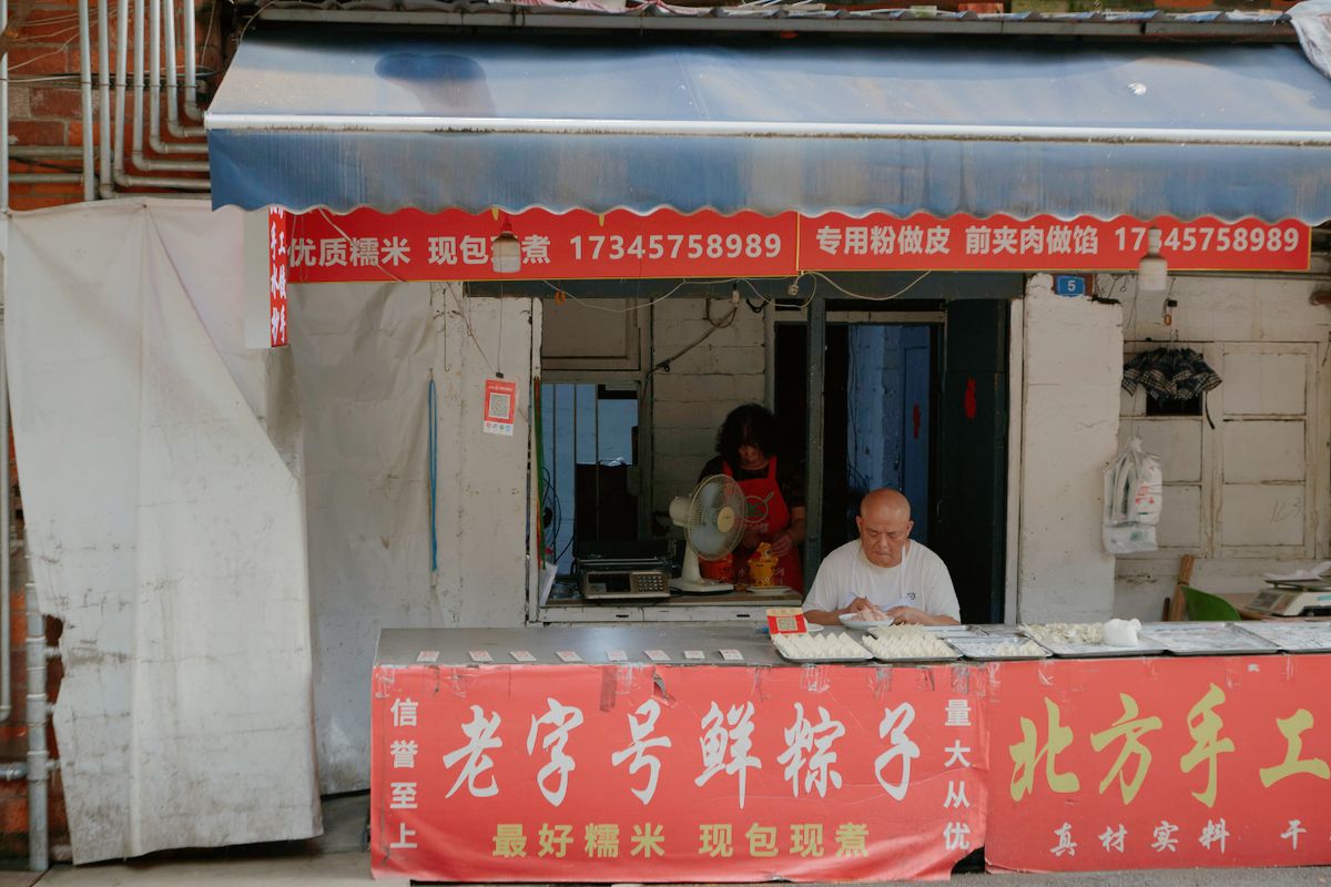 Street food vendor preparing fresh dumplings at an outdoor stall in Shanghai