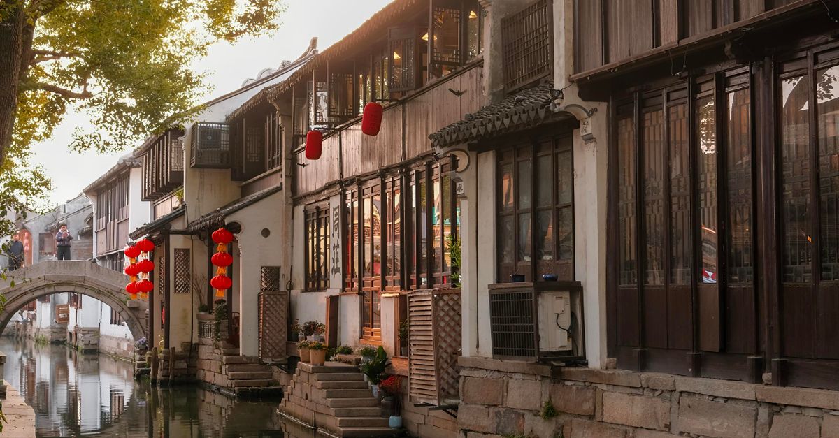 Traditional whitewashed canal houses with red lanterns in Suzhou old town, near the best hotel areas