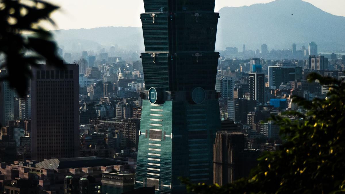 Taipei 101 tower against the Taipei skyline in daylight