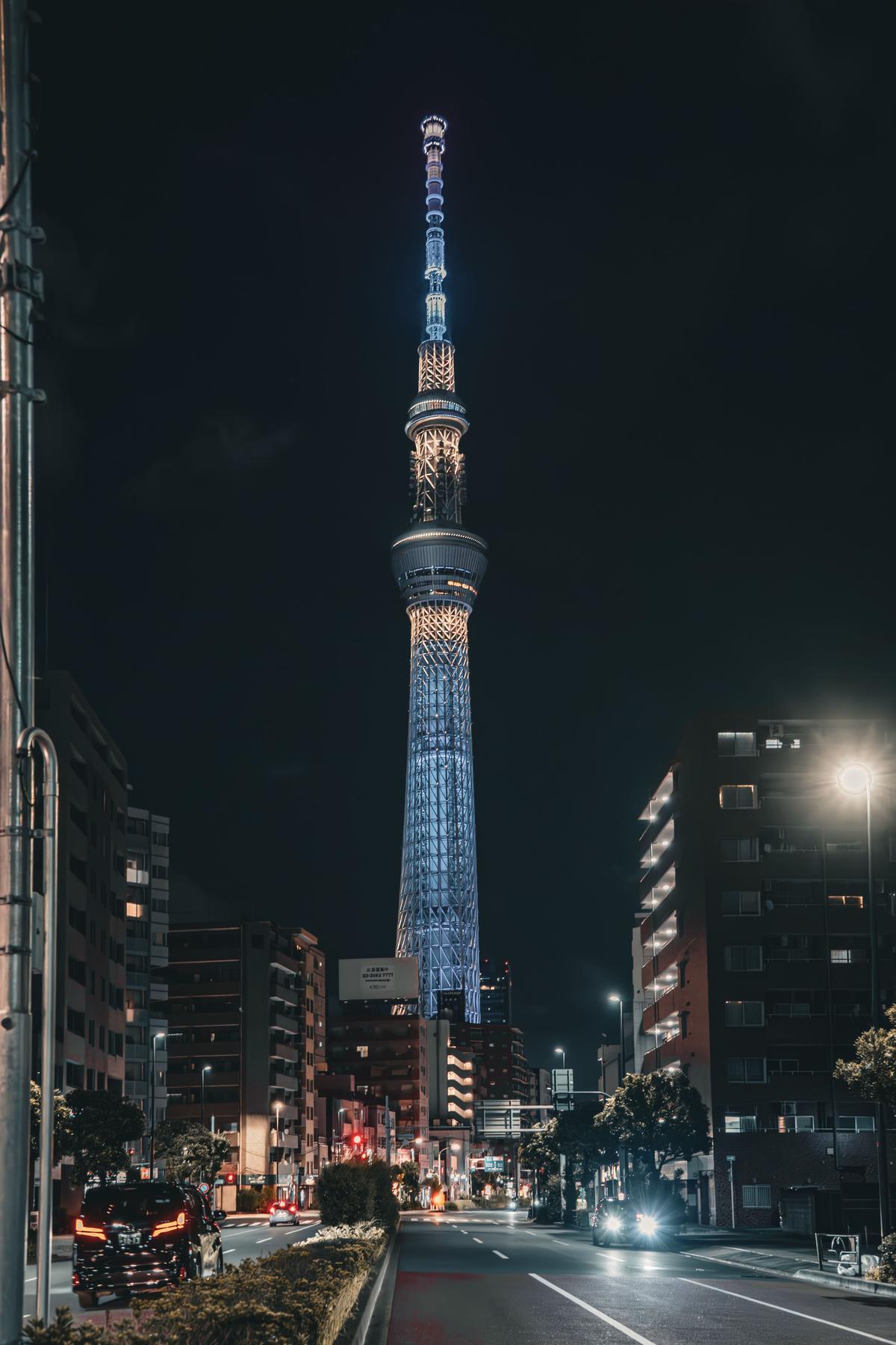 Tokyo Skytree illuminated at night against the city skyline