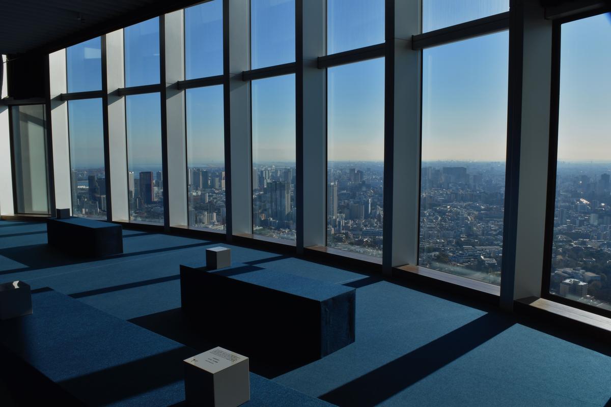Panoramic city view through the glass windows of a Tokyo observation deck